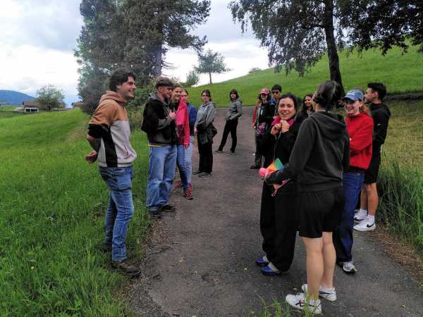 Group of people on an alley with grassland left and right
