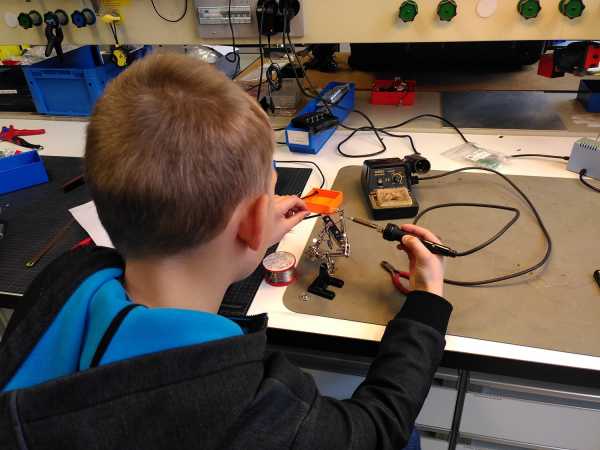 Boy with soldering iron