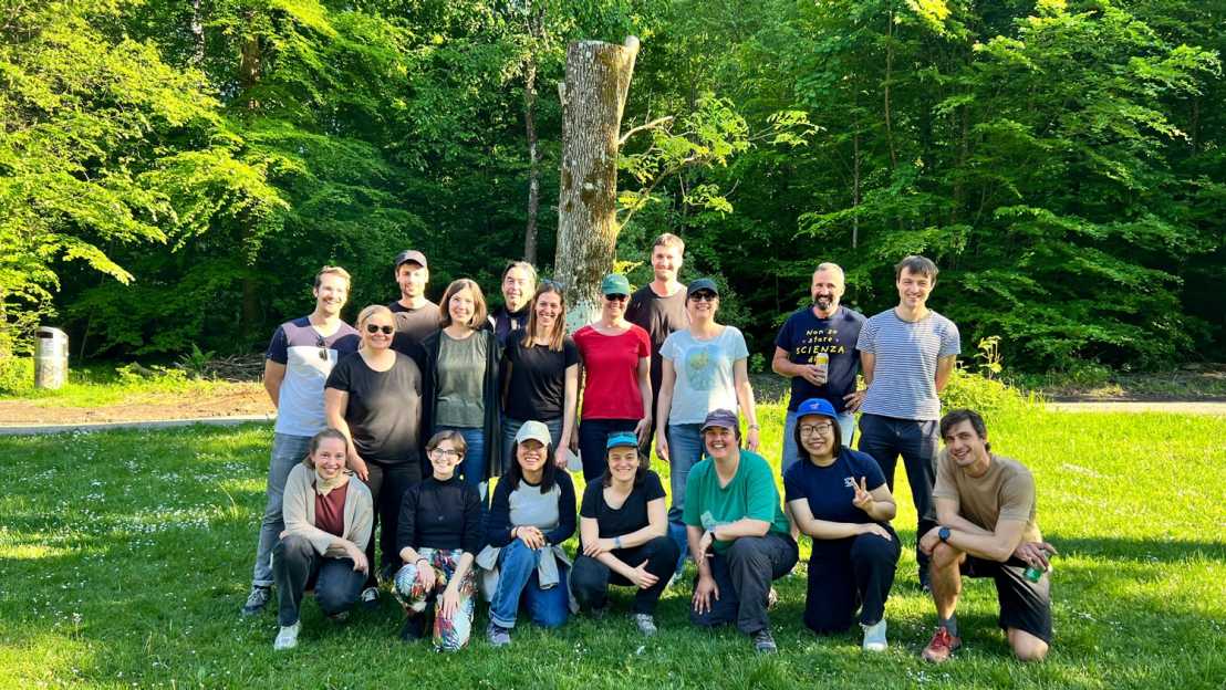 Enlarged view: Group of people on a lawn surrounded by trees