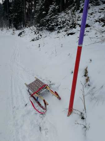 Empty sledge next to pole