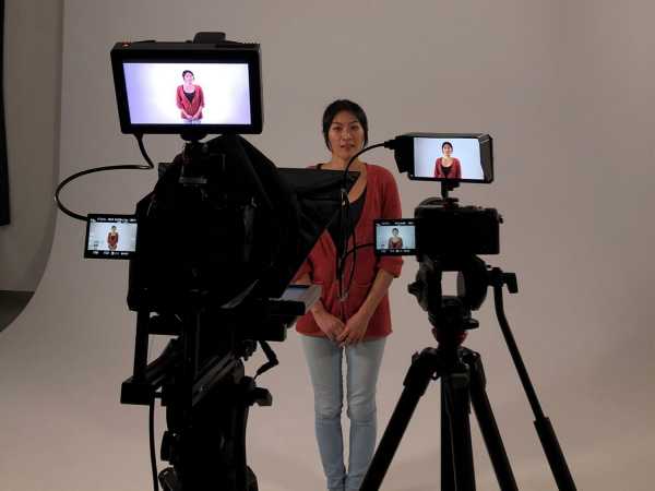 Woman in front of camera in a studio