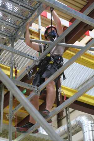 Man climbing on a scaffold in climbing gear