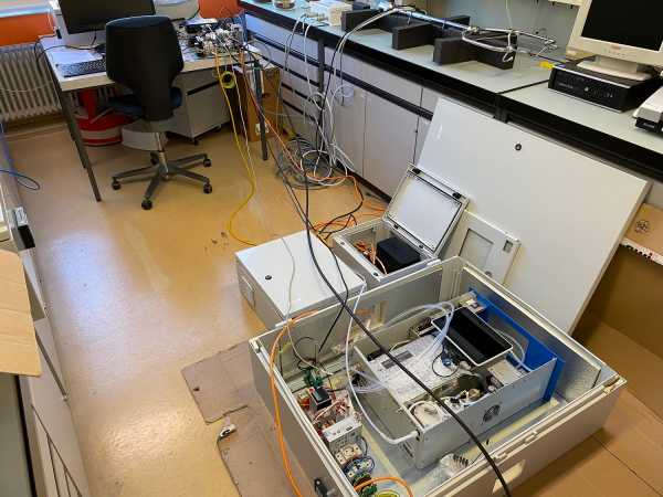 Boxes with cables and measuring device in lab
