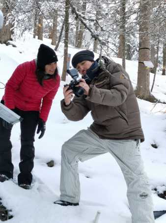 Woman and man looking at picture on camera