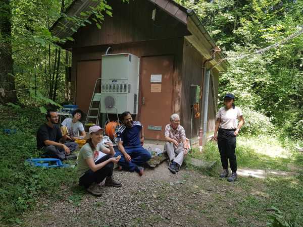 Group in front of hut, taking a break