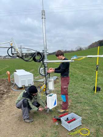 Two men adding things to an eddy tower